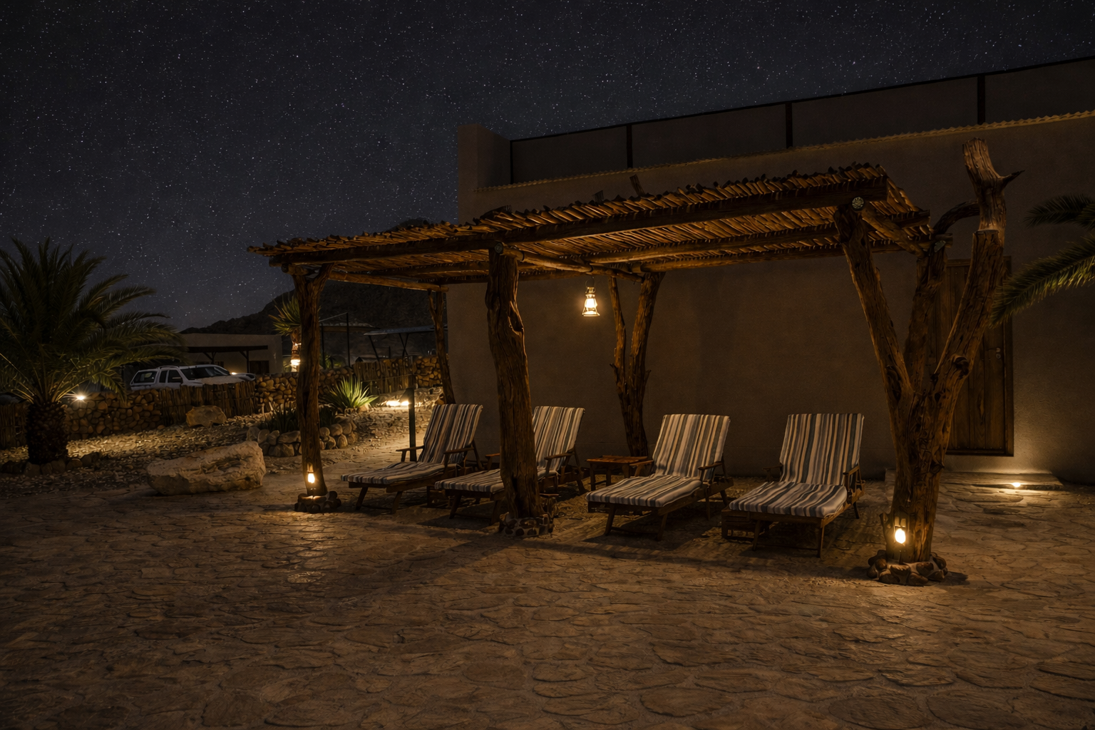 Lounge chairs by the pool at Hohenstein Lodge at night